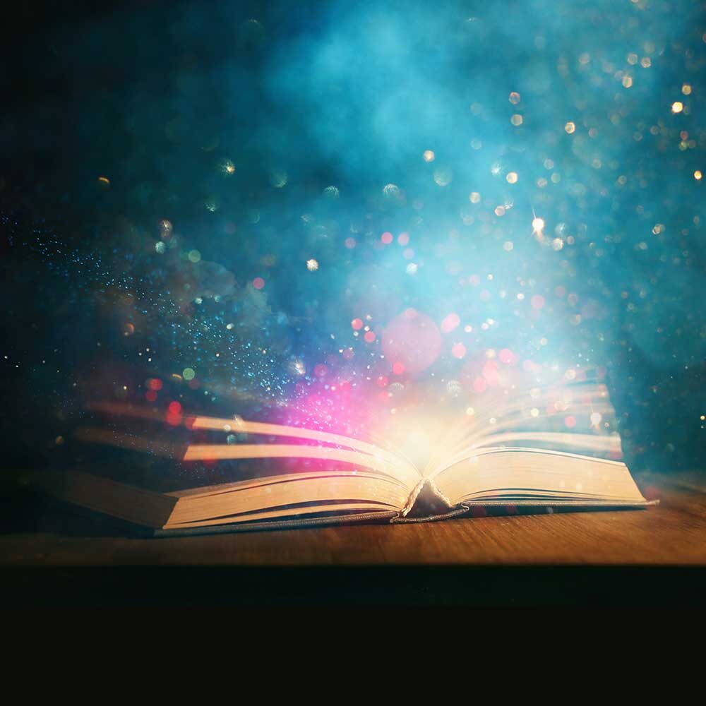 open book with magic sparkles coming out